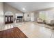 Open-concept living room with vaulted ceilings, neutral paint, tile floors, and large windows with shutters at 222 Hollyfern St, Henderson, NV 89074