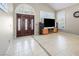 Open-concept living room featuring large windows with shutters, neutral walls, and tile flooring at 222 Hollyfern St, Henderson, NV 89074