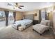 A spacious primary bedroom features a ceiling fan, sitting area, and a balcony view at 222 Hollyfern St, Henderson, NV 89074