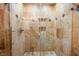 Luxurious shower with textured tile, niche shelving, and a rainfall shower head at 222 Hollyfern St, Henderson, NV 89074