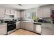 Functional kitchen featuring stainless steel appliances, granite countertops, and ample cabinet space at 2272 Platinum Band St, Las Vegas, NV 89156