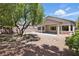 View of backyard with patio, mature trees, and desert landscaping at 2579 Ivoryhill St, Las Vegas, NV 89135