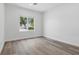 Bright bedroom with light wood flooring and large window with lush greenery at 2579 Ivoryhill St, Las Vegas, NV 89135