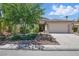 Charming single-story home featuring manicured lawn and a two-car garage, with mature trees providing ample shade at 2579 Ivoryhill St, Las Vegas, NV 89135