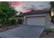 Two car garage with exterior lights and concrete driveway in front of a single story home at 2579 Ivoryhill St, Las Vegas, NV 89135