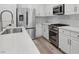 Close-up showcasing the kitchen with stainless steel appliances, marble countertops, and white cabinetry at 2579 Ivoryhill St, Las Vegas, NV 89135