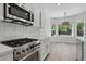 Modern kitchen featuring stainless steel appliances, quartz countertops, and white cabinetry for a clean, sleek look at 2579 Ivoryhill St, Las Vegas, NV 89135