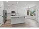 Modern kitchen with stainless steel appliances, island with breakfast bar, and white cabinetry, offering plenty of space at 2579 Ivoryhill St, Las Vegas, NV 89135