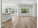 Open-concept living area featuring hardwood floors and plenty of natural light, seamlessly flowing into the kitchen at 2579 Ivoryhill St, Las Vegas, NV 89135