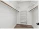 Walk-in closet with white shelves and wood closet rods at 2579 Ivoryhill St, Las Vegas, NV 89135