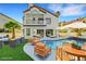 Backyard with a pool, lawn, patio furniture, and a view of the house at 2589 Sun Reef Rd, Las Vegas, NV 89128