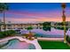 A backyard featuring an inground pool, a lake, and a private dock at 2589 Sun Reef Rd, Las Vegas, NV 89128