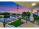 A covered outdoor balcony overlooking a lake with a fountain and manicured landscaping at 2589 Sun Reef Rd, Las Vegas, NV 89128