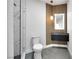 Modern bathroom with sleek vanity, wood slat accent wall, and marble-tiled shower at 2589 Sun Reef Rd, Las Vegas, NV 89128