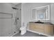 Modern bathroom with a glass shower, illuminated mirror, and sleek vanity with a black countertop at 2589 Sun Reef Rd, Las Vegas, NV 89128
