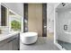 Modern bathroom featuring a soaking tub, shower, and vanity with dark cabinets at 2589 Sun Reef Rd, Las Vegas, NV 89128