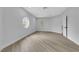 This bedroom has a charming round window and is complemented by light wood flooring and white trim at 2589 Sun Reef Rd, Las Vegas, NV 89128