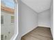 Well-lit bedroom with wood floors and a window offering a view of a neighboring house with a red tile roof at 2589 Sun Reef Rd, Las Vegas, NV 89128
