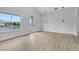 Bright bedroom with a lake view, large windows, and wood-look flooring at 2589 Sun Reef Rd, Las Vegas, NV 89128