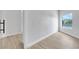 Bright bedroom with wood-look flooring and a large window with a serene lake view at 2589 Sun Reef Rd, Las Vegas, NV 89128
