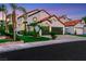 A white stucco two-story home with a red tile roof, attached garage, and well-manicured landscaping at 2589 Sun Reef Rd, Las Vegas, NV 89128