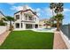 Stunning two-story home with a pool, lush lawn, and elegant architectural details, perfect for luxurious living at 2589 Sun Reef Rd, Las Vegas, NV 89128