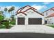 Charming two-story home with a two-car garage, terracotta roof, and landscaped yard at 2589 Sun Reef Rd, Las Vegas, NV 89128