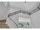 Bright foyer with modern staircase, contemporary lighting, and expansive windows to the backyard at 2589 Sun Reef Rd, Las Vegas, NV 89128
