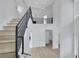 Spacious foyer with modern staircase, contemporary lighting, and light wood flooring at 2589 Sun Reef Rd, Las Vegas, NV 89128