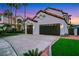 Spacious three-car garage with an extended driveway, set against a well-maintained lawn and manicured landscaping at 2589 Sun Reef Rd, Las Vegas, NV 89128