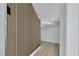 Hallway features a modern slat wood accent wall and light wood-look flooring at 2589 Sun Reef Rd, Las Vegas, NV 89128