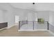 Hallway with black metal railing, modern lighting, and light wood floors at 2589 Sun Reef Rd, Las Vegas, NV 89128