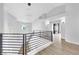Bright hallway features modern lighting, black metal railing, and light wood floors at 2589 Sun Reef Rd, Las Vegas, NV 89128