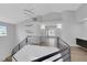 Bright hallway features modern lighting, black metal railing, and open space at 2589 Sun Reef Rd, Las Vegas, NV 89128