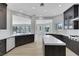 Bright kitchen with dark cabinetry, stainless steel appliances, and a central island with a white countertop at 2589 Sun Reef Rd, Las Vegas, NV 89128