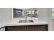 Kitchen sink featuring quartz countertops, dark wood cabinets, and a stainless steel faucet at 2589 Sun Reef Rd, Las Vegas, NV 89128
