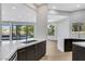 Open-concept kitchen with an island featuring bar seating and views of the backyard at 2589 Sun Reef Rd, Las Vegas, NV 89128