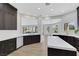 Bright kitchen showcasing dark wood cabinets, quartz countertops, and open layout at 2589 Sun Reef Rd, Las Vegas, NV 89128