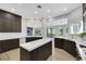 Modern kitchen featuring dark wood cabinets, quartz countertops, and stainless steel appliances at 2589 Sun Reef Rd, Las Vegas, NV 89128