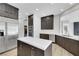 Spacious kitchen with dark wood cabinetry, stainless steel appliances, and a central island with a white countertop at 2589 Sun Reef Rd, Las Vegas, NV 89128