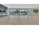 Expansive living room with light wood floors, floor-to-ceiling windows, and a modern fireplace at 2589 Sun Reef Rd, Las Vegas, NV 89128