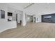 Expansive living room with open floor plan, light wood flooring, modern fireplace, and high-end finishes at 2589 Sun Reef Rd, Las Vegas, NV 89128