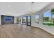 Open living area with modern lighting, statement fireplace, and views of the landscaped backyard at 2589 Sun Reef Rd, Las Vegas, NV 89128