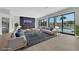 Spacious living room with modern furniture, fireplace, and large windows overlooking the pool at 2589 Sun Reef Rd, Las Vegas, NV 89128