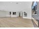 Open-concept living room with hardwood floors, recessed lighting, and view of a modern fireplace at 2589 Sun Reef Rd, Las Vegas, NV 89128