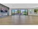 Spacious living room with modern fireplace and large windows overlooking the outdoor pool at 2589 Sun Reef Rd, Las Vegas, NV 89128