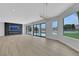 Bright living room boasts a modern fireplace, recessed lighting, and expansive windows overlooking the pool area at 2589 Sun Reef Rd, Las Vegas, NV 89128