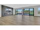 Bright living room featuring a modern fireplace and expansive windows showcasing the backyard at 2589 Sun Reef Rd, Las Vegas, NV 89128