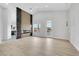 Spacious living room with modern fireplace, wood floors, and access to outdoor balcony at 2589 Sun Reef Rd, Las Vegas, NV 89128