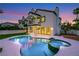 A clear swimming pool and hot tub create a luxurious backyard retreat, with house in the background at 2589 Sun Reef Rd, Las Vegas, NV 89128